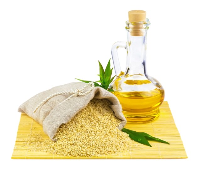 Sack of sesame seeds and glass bottle of oil