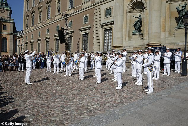 The royals watched as the Swedish Royal Navy Band played in front of the Royal Palace in Stockholm this morning