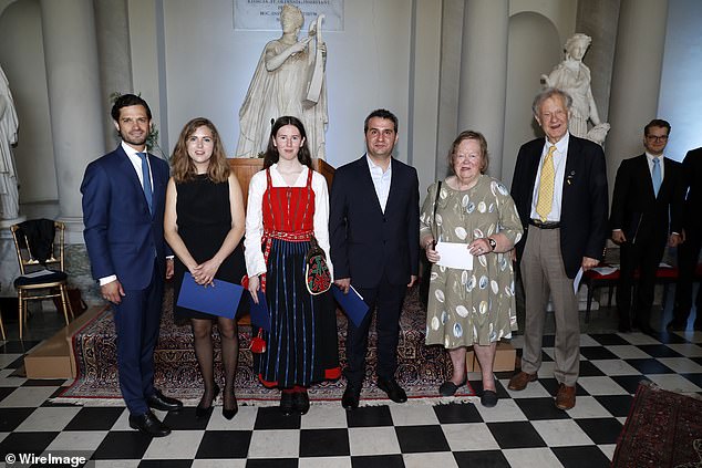 The Prince was seen posing alongside winners of the scholarship award inside the Royal Palace earlier today