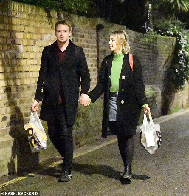 Saoirse and Jack strolling hand-in-hand after a trip to the Co-op store near her flat in West London