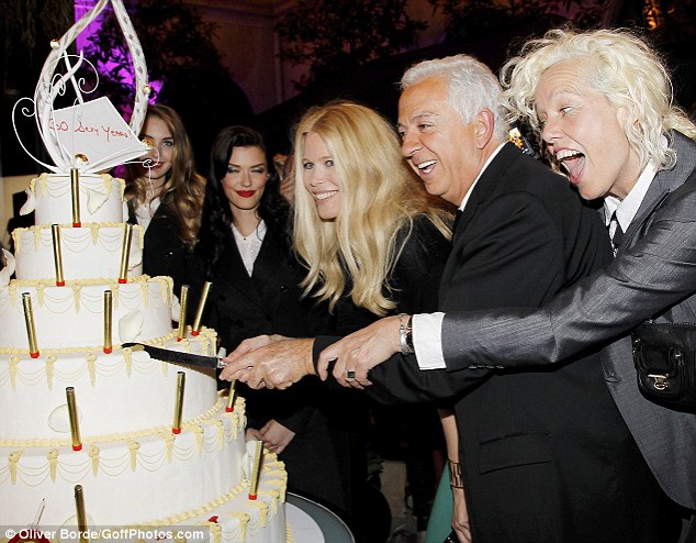 Cutting the cake: Claudia poses with designer Paul Marciano and photographer Ellen Von Unwerth