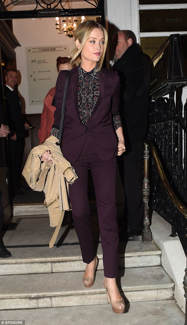 City chic: The 29-year-old kept things classy in a burgundy coloured tailored suit, which she teamed with nude peep-toes