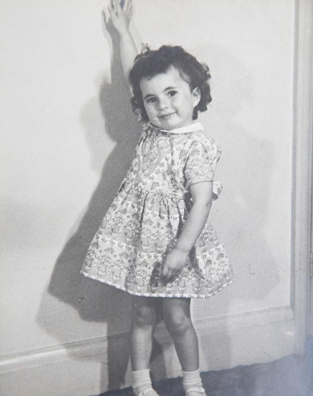 Angela Levin aged three wearing the dress she left home in. As a child, Angela