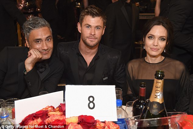 Side by side: Chris sat next to Angelina at the Golden Globes last week 